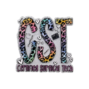 May include: A decorative pin featuring the letters CST in a colorful rainbow leopard print pattern. The design includes small white hearts, a surgical needle, and a suture graphic. Below the letters, the text reads Certified Surgical Tech.