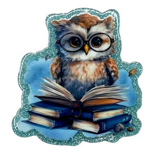 May include: A whimsical illustration of an owl wearing glasses, perched atop a stack of books. The owl is brown and white with large eyes, and the books are blue. The image has a glittery, light blue border.