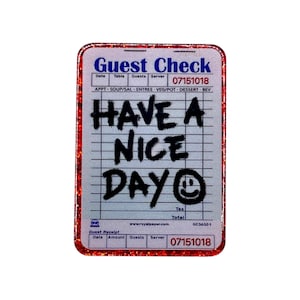 May include: A rectangular sticker resembling a guest check, with a red glitter border. The top reads "Guest Check" in blue, with the date "07151018." The center features the phrase "HAVE A NICE DAY" in black, with a smiley face.