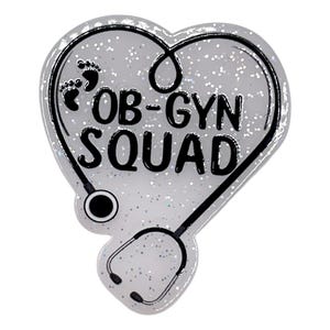 May include: A heart-shaped badge with a stethoscope design and the words "OB-GYN SQUAD" in black. The badge has a glittery, silver background and two baby footprints. The stethoscope is black and outlines the heart shape.