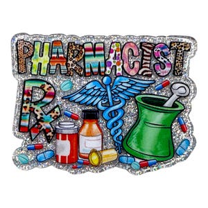 May include: A glittery pharmacist-themed badge with the word "PHARMACIST" in colorful, patterned letters. The design includes a caduceus, mortar and pestle, prescription symbol, pills, and medicine bottles. The badge is approximately 3 inches wide.