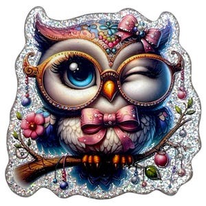 May include: A whimsical owl illustration with a winking eye, wearing glasses and a pink bow tie. The owl is perched on a branch with hanging ornaments, surrounded by a glittery border. The owl has blue eyes and is decorated with pink and blue accents.
