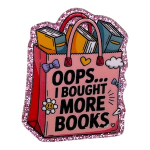 May include: A pink glittery shopping bag pin with the text "OOPS... I BOUGHT MORE BOOKS." The bag is filled with books in yellow and blue. Additional details include bows, a heart, a cloud, and a flower.