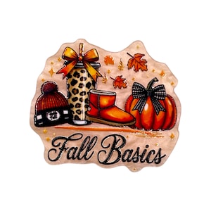May include: A decorative acrylic piece featuring a leopard print tumbler with an orange bow, a red knit beanie, a tan boot, and an orange pumpkin with a black and white plaid bow. The text Fall Basics is printed in black script at the bottom.