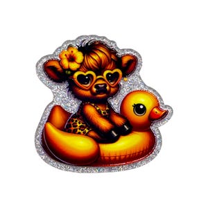 May include: A whimsical illustration of a brown cow wearing heart-shaped sunglasses and a leopard print swimsuit, riding a yellow inflatable duck. The image has a glittery silver border and a flower in the cow's hair.