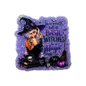 May include: A purple sticker featuring a witch with white hair and a black hat, a skull, a broom, and pumpkins. The text reads: In a world full of BASIC WITCHES be a Magic one. The design includes stars, sparkles, and a mug labeled Witch's Brew.