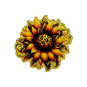 May include: A decorative sunflower with a leopard print center and petals. The sunflower is in shades of yellow, orange, and brown, with a gold glitter border. The design is a vibrant and eye-catching floral accent.
