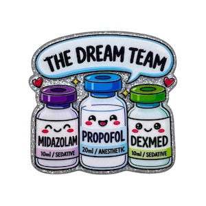 May include: A glittery enamel pin featuring three cartoon medicine vials with smiling faces. The vials are labeled Midazolam 10ml/Sedative, Propofol 20ml/Anesthetic, and Dexmed 10ml/Sedative. Above them, a speech bubble contains the text THE DREAM TEAM.