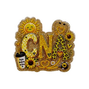 May include: A glittery decorative cutout featuring the letters CNA in yellow and black patterns. It includes a smiling sun, sunflowers, a stethoscope, and a coffee cup with the text Caring, Nurturing, Amazing. The design is accented with small hearts.