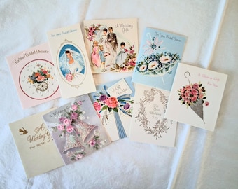 May include: A collection of vintage wedding and bridal shower greeting cards. The cards feature illustrations of brides, flowers, and decorative elements. Text includes phrases like "For Your Bridal Shower" and "A Wedding Gift For You."