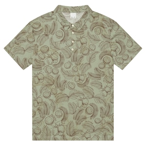 May include: A short-sleeved polo shirt with a light green background and a repeating pattern of coconuts and palm fronds in brown. The shirt has a collared neckline and button closure.