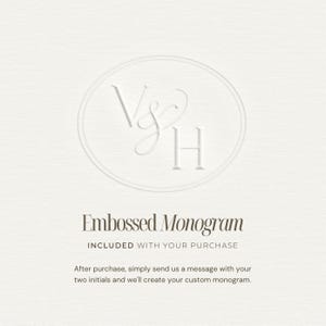 May include: A white textured card featuring an embossed oval monogram with the letters V and H connected by an ampersand. The text reads Embossed Monogram, INCLUDED WITH YOUR PURCHASE, and instructions to send a message with two initials.