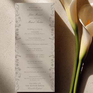 May include: A wedding program with a floral border and text. The program lists the wedding ceremony details, including prelude, processional, readings, and recessional. The names Juliet Bennet and Michael Sinclair are featured. The date is September 5th.
