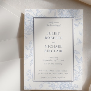 May include: A wedding invitation with a floral design in light blue on a cream background. The invitation includes the names Juliet Roberts and Michael Sinclair, the date, time, and location.