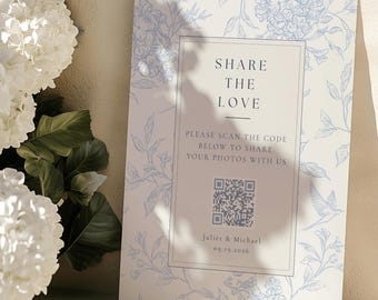 May include: A rectangular sign featuring a light blue floral and bird pattern on a white background. The center text reads SHARE THE LOVE, PLEASE SCAN THE CODE BELOW TO SHARE YOUR PHOTOS WITH US, a QR code, Juliet & Michael, and 09.19.2026.