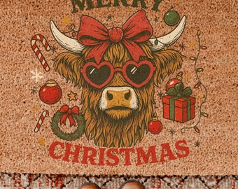 May include: A rectangular coir doormat with a festive design. It features a Highland cow wearing heart-shaped sunglasses and a red bow, with the words "MERRY CHRISTMAS" in a vintage font. Christmas ornaments and lights complete the holiday theme.