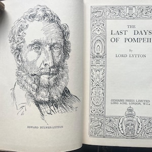 May include: An open book with a black and white illustration of a man with a beard and mustache. The text reads "The Last Days of Pompeii" by Lord Lytton. The book is from Odhams Press Limited.