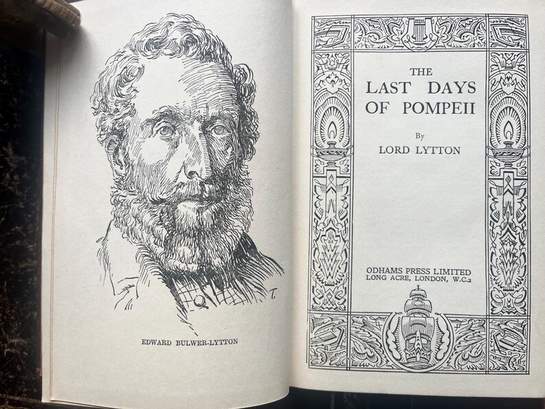 May include: An open book with a black and white illustration of a man with a beard and mustache. The text reads "The Last Days of Pompeii" by Lord Lytton. The book is from Odhams Press Limited.