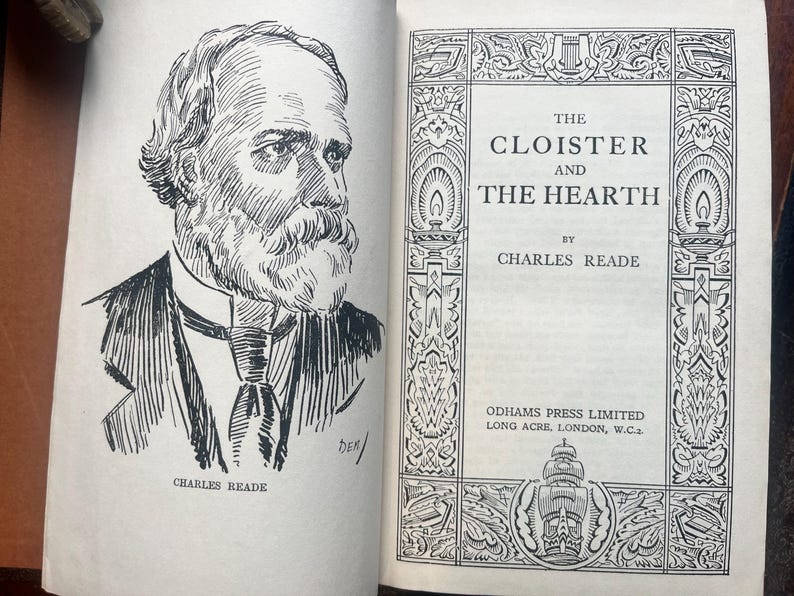 May include: An open book with a black and white illustration of a man with a beard and the title "The Cloister and the Hearth" by Charles Reade. The book's cover features decorative borders and the publisher's information.