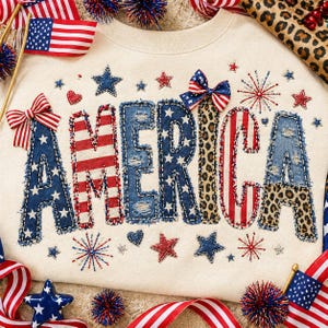 May include: Cream-coloured sweatshirt with the word "AMERICA" in a patchwork design. The letters feature denim, leopard print, and red and white stripes. Embellishments include stars, hearts, and bows in patriotic colours, ideal for celebrating Independence Day.