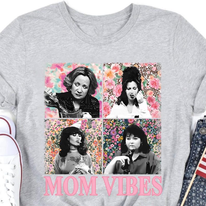 The image is a t-shirt featuring a collage of four black and white photographs of women, with the text "MOM VIBES" prominently displayed.