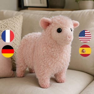 May include: A plush toy shaped like a lamb with soft, curly, light pink fur. The lamb has two small, rounded ears, a textured coat, and two dark, round, glossy eyes. It stands on four short legs and has a simple, stitched mouth detail.