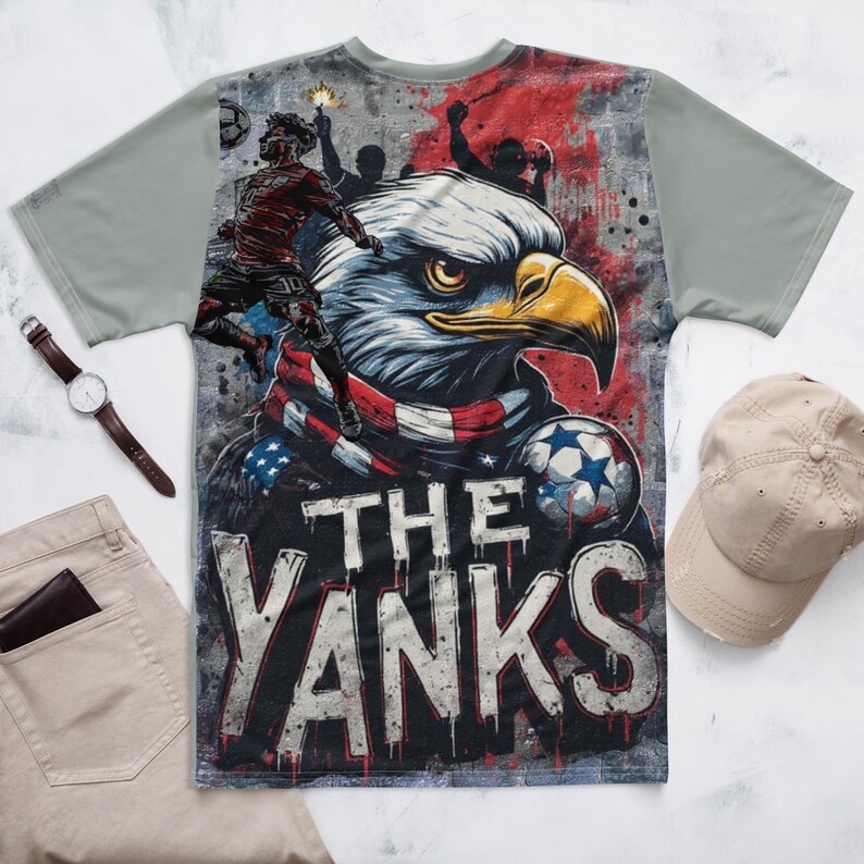 Double-side All print shirt for World Cup support to Team USA. Pride of USA graphic featuring Eagle with USA flag scarf, in graffiti mural with elevated US player in stylized silhouette heading a ball.