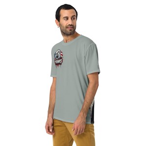May include: A light gray t-shirt featuring a graphic of an eagle with the text "Yanks" on the front. The eagle graphic incorporates red, white, and blue colors, and the shirt has a crew neck and short sleeves.