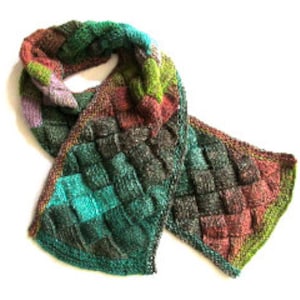May include: A multi-colored knitted scarf with a woven pattern. The scarf is made with shades of green, brown, purple, and teal.