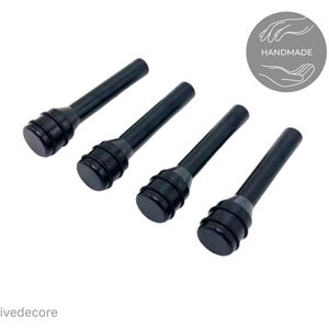 May include: Four black car door lock pins. Each pin has a cylindrical stem and a rounded top with a grooved design. The pins are arranged diagonally on a white background. The word "Handmade" is in a circle.