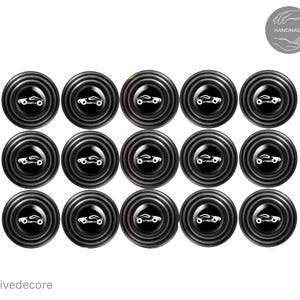 May include: A collection of fifteen black car door protectors with a circular design. Each protector features a white car silhouette in the center. The word "HANDMADE" is in a circle in the upper right corner. The brand name "Drivedecore" is at the bottom.