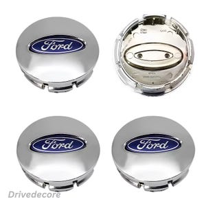 May include: Four chrome Ford wheel centre caps. Each cap is round with a blue oval centre featuring the Ford logo in white script. One cap is shown from the back, revealing its mounting mechanism. The caps are new.