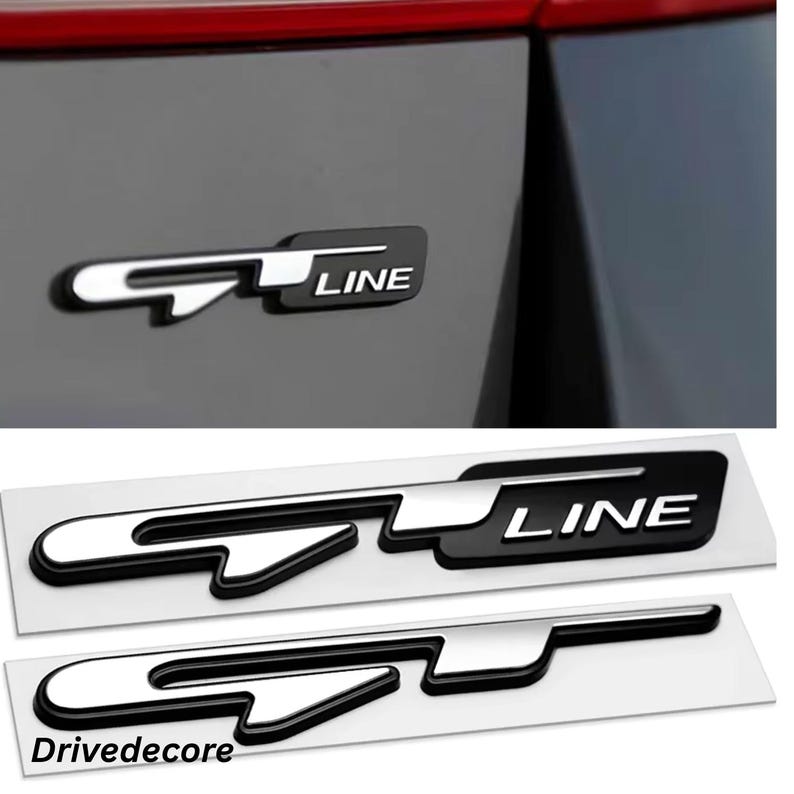 May include: Black and silver GT LINE emblem. The emblem is shown on a car and also on a white backing. The text "GT LINE" is visible on the emblem. The brand name "Drivedecore" is also visible.