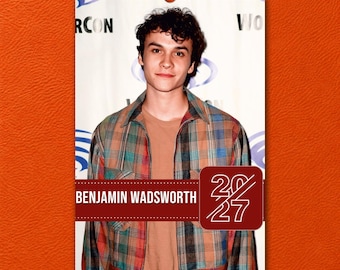 May include: A wall calendar featuring a portrait of Benjamin Wadsworth wearing a plaid button-down shirt over a tan t-shirt. The calendar includes the text BENJAMIN WADSWORTH and 2027 in a dark red rectangular banner at the bottom of the page.