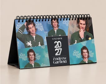 May include: A 2027 desk calendar featuring multiple photographs of Andrew Garfield wearing a green patterned cardigan. The calendar has a black spiral binding at the top and a central black panel with the text Calendar 2027 Andrew Garfield.