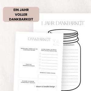 以下が含まれることがあります： 「Ein Jahr Voller Dankbarkeit」と「I Jahr Dankbarkeit」のテキストが入った感謝のジャーナル。人々、小さなこと、ポジティブな驚き、喜びの瞬間をリストするためのセクションが含まれています。ジャーのイラストも表示されています。