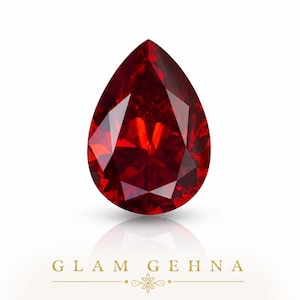 May include: A faceted, pear-shaped, deep red gemstone. The gem has a brilliant cut, reflecting light and creating a sparkling effect. The word "GLAM GEHNA" is printed in gold at the bottom of the image.