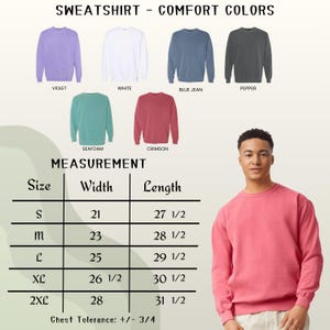 May include: A selection of Comfort Colors sweatshirts in various hues, including violet, white, blue jean, pepper, seafoam, and crimson. The image also includes a size chart with measurements in inches for width and length, ranging from size small to 2XL.