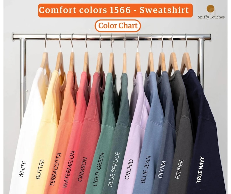 May include: A color chart of Comfort Colors 1566 sweatshirts in various hues, including white, butter, terracotta, watermelon, crimson, light green, blue spruce, orchid, blue jean, denim, pepper, and true navy. The text "Comfort colors 1566 - Sweatshirt" is displayed.