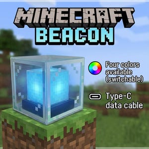 May include: A Minecraft Beacon light with a glowing blue core, enclosed in a clear, cube-shaped casing. The text "MINECRAFT BEACON" is displayed above. The image also shows the text "Four colours available (switchable)" and "Type-C data cable".