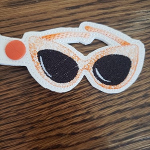 dark lens, orange sunglasses key chain/snap tab