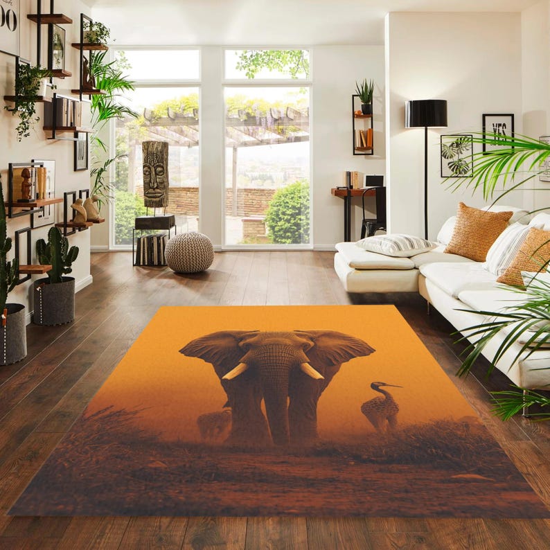 May include: A rectangular area rug featuring an elephant and a bird in a savanna landscape. The rug has a warm orange and brown color palette, with the elephant as the central focus. The rug is placed on a hardwood floor.