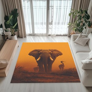 May include: A rectangular area rug featuring an elephant with large tusks and a bird in a savanna setting. The rug has an orange background with brown and tan details, suitable for a living room.