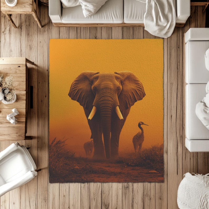 May include: A rectangular area rug featuring an elephant illustration. The elephant is brown with large ears and tusks, set against a warm orange background. A bird and a smaller elephant are also visible. The rug is designed for home decor.