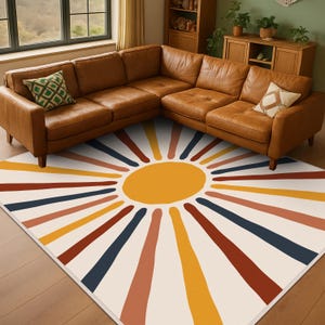 May include: A rectangular rug with a sunburst pattern in a living room setting. The rug has a central yellow circle with colourful stripes radiating outwards. The colours include red, blue, and orange. The rug is placed under a brown leather corner sofa.
