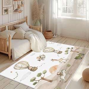 Könnte beinhalten: Ein rechteckiger Teppich mit einem skurrilen Safari-Thema. Der Teppich zeigt Illustrationen von Heißluftballons, einer Giraffe, einem Zebra und einem Doppeldecker, alles in weichen, gedämpften Farben. Der Teppich liegt auf einem Holzboden.