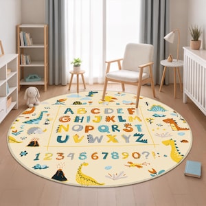 May include: A round, cream-colored rug featuring a dinosaur theme. The rug displays the alphabet and numbers in a colorful, playful font. Dinosaurs, volcanoes, and other prehistoric elements are scattered around the edges.