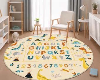 May include: A round, cream-colored rug featuring a dinosaur theme. The rug displays the alphabet and numbers in a colorful, playful font. Dinosaurs, volcanoes, and other prehistoric elements are scattered around the edges.
