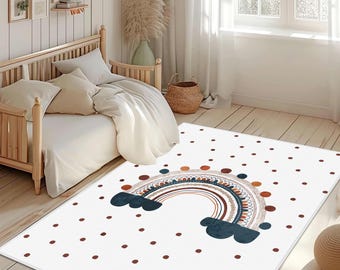 May include: White rectangular rug with a rainbow design and scattered brown dots. The rainbow features shades of brown, blue, and orange. The rug is placed in a bedroom setting with a wooden bed and neutral-toned bedding.