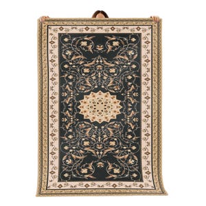 May include: A rectangular blanket with an intricate floral pattern in dark teal, beige, and cream. The design features a central medallion and a detailed border. The blanket is held up against a white background.